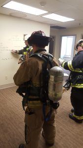 Two Firefighters Listening to the Instructor