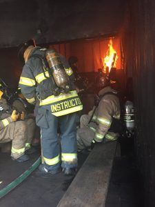 Three Firefighters Putting Out a Fire